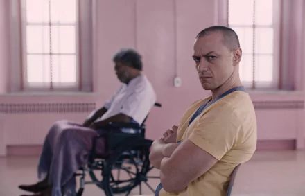 HD desktop wallpaper featuring James McAvoy from the movie Glass, with a character in a wheelchair in the background.