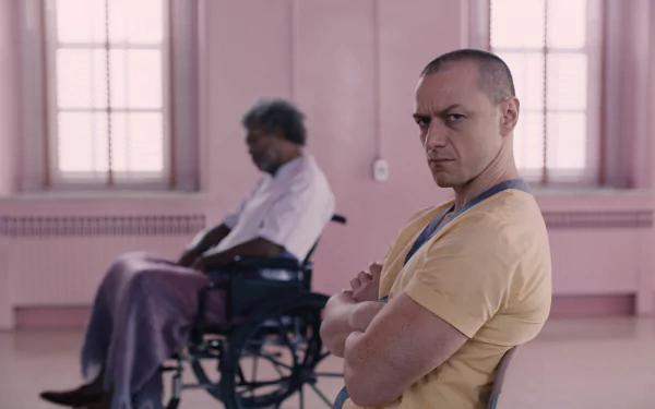 HD desktop wallpaper featuring James McAvoy from the movie Glass, with a character in a wheelchair in the background.