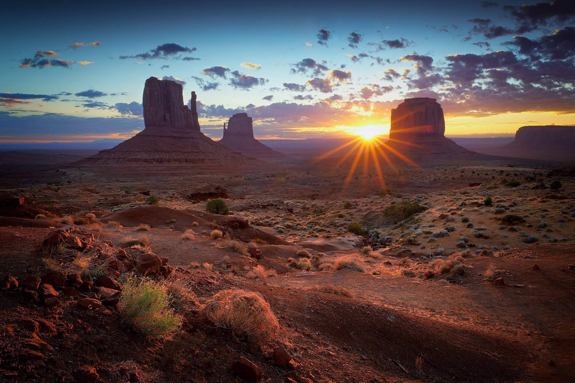 Sunrise over Monument Valley desert landscape in the USA, captured in stunning HD for a dramatic nature desktop wallpaper and background.