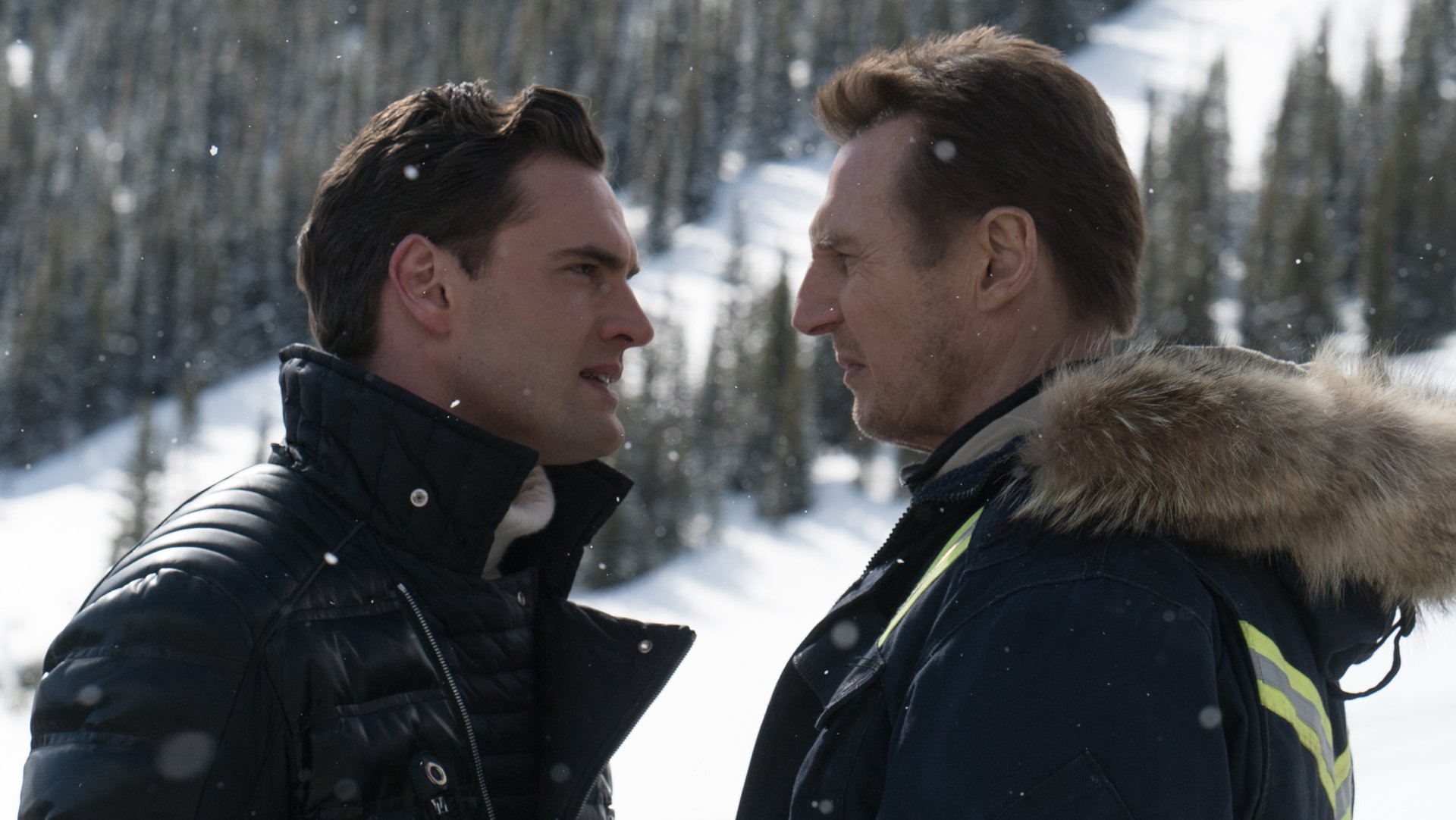 Two characters face off in a snowy landscape from the movie Cold Pursuit, featuring Liam Neeson. This HD image captures the intensity of their confrontation.