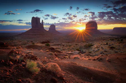 Sunrise over Monument Valley desert landscape in the USA, captured in stunning HD for a dramatic nature desktop wallpaper and background.
