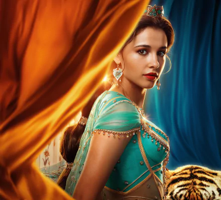 HD wallpaper of British actress Naomi Scott, dressed as Princess Jasmine from the movie Aladdin (2019). She has brown eyes, is wearing lipstick and earrings, and is surrounded by colorful fabric.