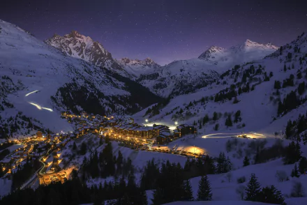Snow-covered French mountain village illuminated at night under a clear starry winter sky, captured in HD for a stunning desktop wallpaper.