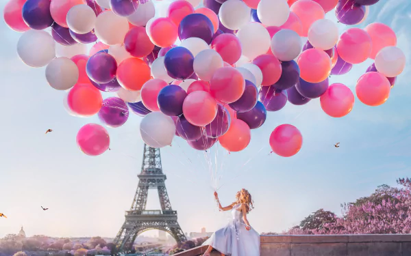 8K Ultra HD PC wallpaper/background: blonde model in a flowing white dress releasing pink and purple balloons on a Paris terrace with the Eiffel Tower at sunset, dreamy mood.