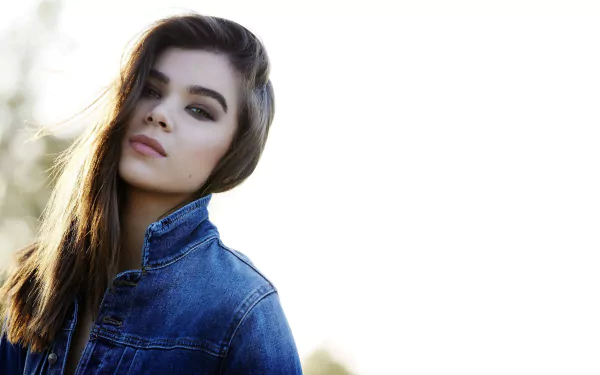 HD desktop wallpaper of American singer and actress Hailee Steinfeld, showcasing a brunette in a denim jacket with a depth of field effect.