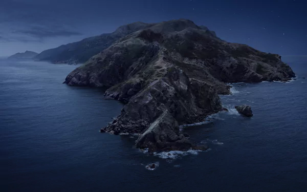 Night view of Santa Catalina Island surrounded by ocean waves, featured as a 4K Ultra HD macOS desktop wallpaper by Apple Inc.