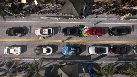 Top-down HD PC desktop wallpaper/background from the video game Need for Speed Heat showing colorful sports cars lined on a sunlit city street with palm trees and crowds.
