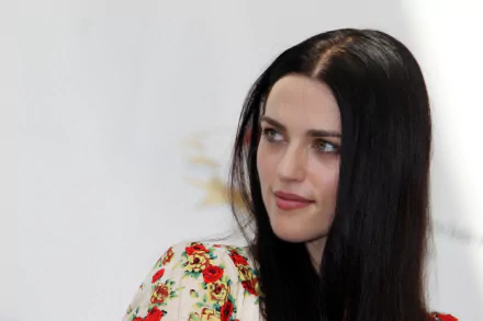 Close-up portrait of a woman with long black hair in a floral top, looking to the side — 2K Quad HD PC desktop wallpaper.