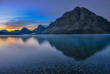 A serene view of a mountain reflected in the calm lake waters at Banff National Park, Canada, captured in HD for a stunning desktop wallpaper.