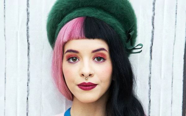 American singer Melanie Martinez wears a green hat and bold lipstick in this HD PC desktop wallpaper and background.