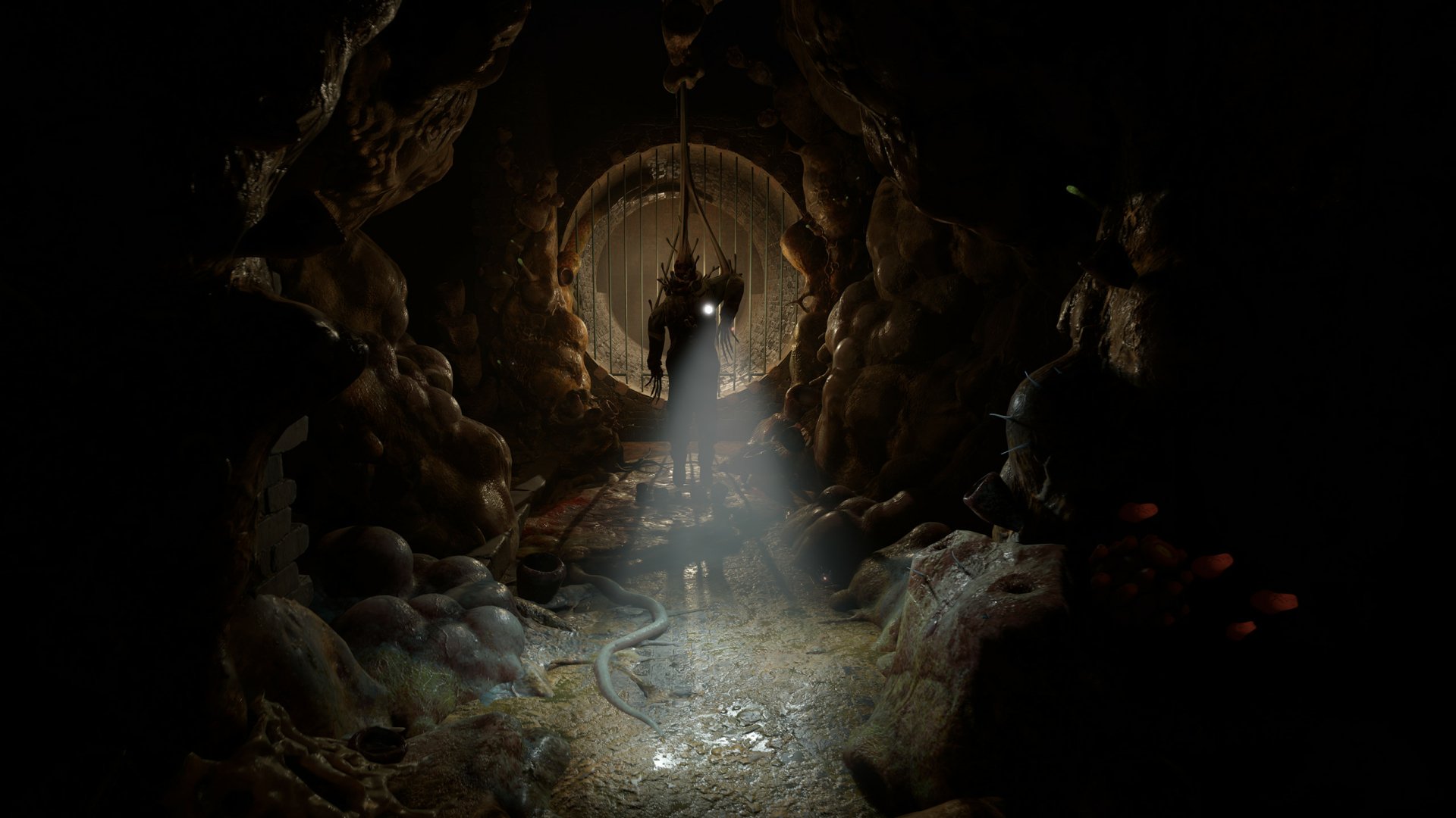 Dark, atmospheric HD PC desktop wallpaper from the video game Half-Life: Alyx, featuring a mysterious figure illuminated by a beam of light inside a cavernous tunnel.