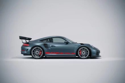 HD desktop wallpaper featuring a sleek Porsche 911 GT3 RS sports car in gray with red accents, showcasing its dynamic design and performance.