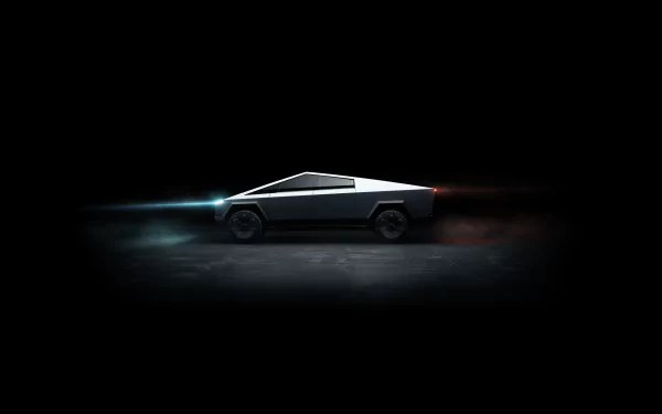 Sleek Tesla Cybertruck vehicle showcased in dramatic lighting on a dark background, rendered in 4K Ultra HD for a striking PC desktop wallpaper.