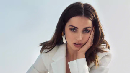 HD desktop wallpaper featuring a close-up of Cuban actress Ana de Armas with brunette hair, wearing a white outfit and elegant earrings against a light background.