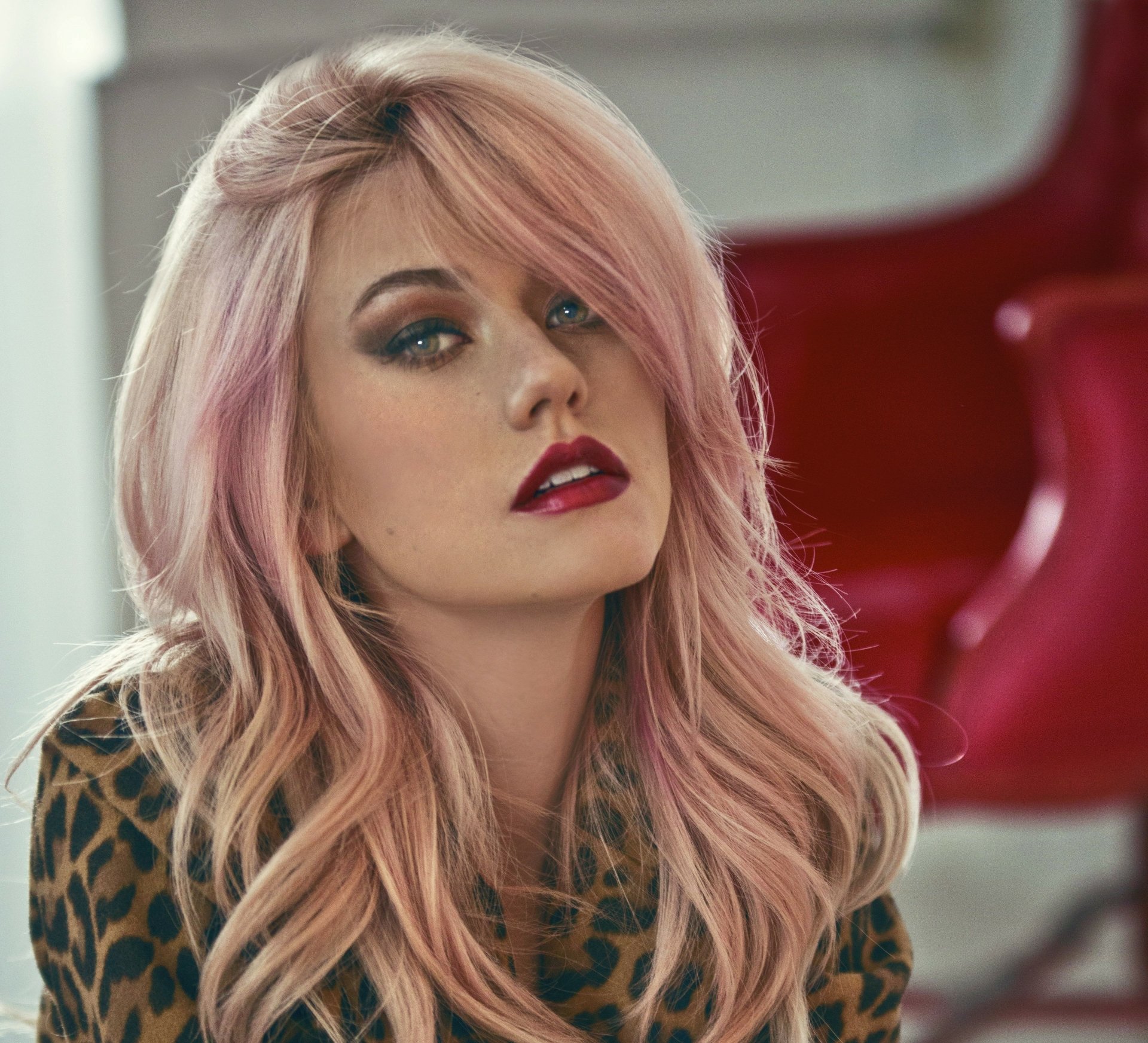 Close-up portrait of American actress Katherine McNamara with pink hair, blonde highlights, and bold lipstick, captured in 4K Ultra HD quality.