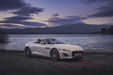 White Jaguar F-Type convertible parked by a lakeside at dusk, captured in stunning 4K Ultra HD for a PC desktop wallpaper.