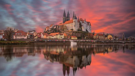 HD PC desktop wallpaper of Albrechtsburg Castle in Meissen, Germany at sunset, the medieval town and spires reflected in the river, a dramatic man-made silhouette.