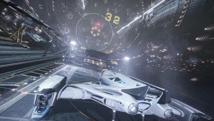 HD PC desktop wallpaper: sleek spaceship inside a vast space station from the video game Elite: Dangerous, cockpit view with glowing lights and towering docking bays.