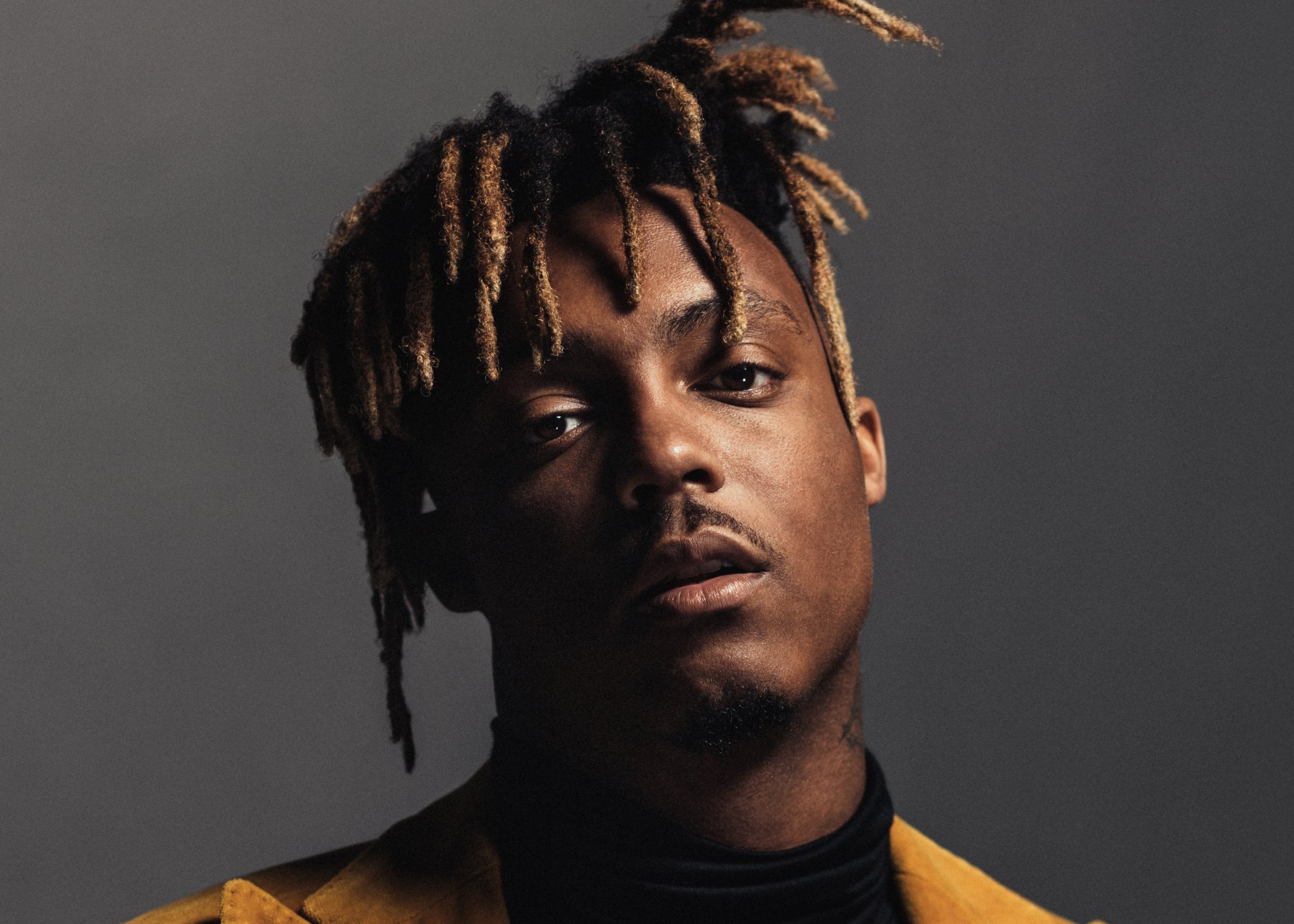 Close-up portrait of rapper and singer Juice Wrld against a dark background, featured as a 4K Ultra HD PC desktop wallpaper.
