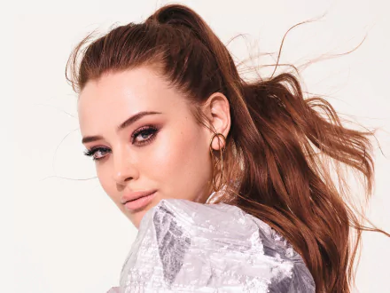 Close-up portrait of Australian actress Katherine Langford with red hair and striking blue eyes, captured in an HD desktop wallpaper style.