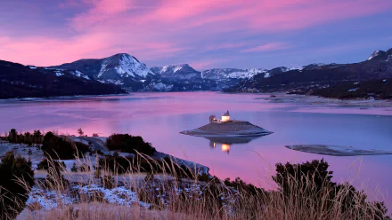 HD PC desktop wallpaper/background: a religious chapel on a small island in a mountain lake at sunset, pink sky and snow-capped peaks reflected in calm, tranquil water.