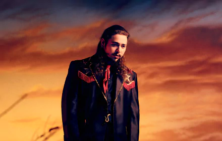 HD wallpaper of Post Malone in a black jacket against a dramatic sky background.
