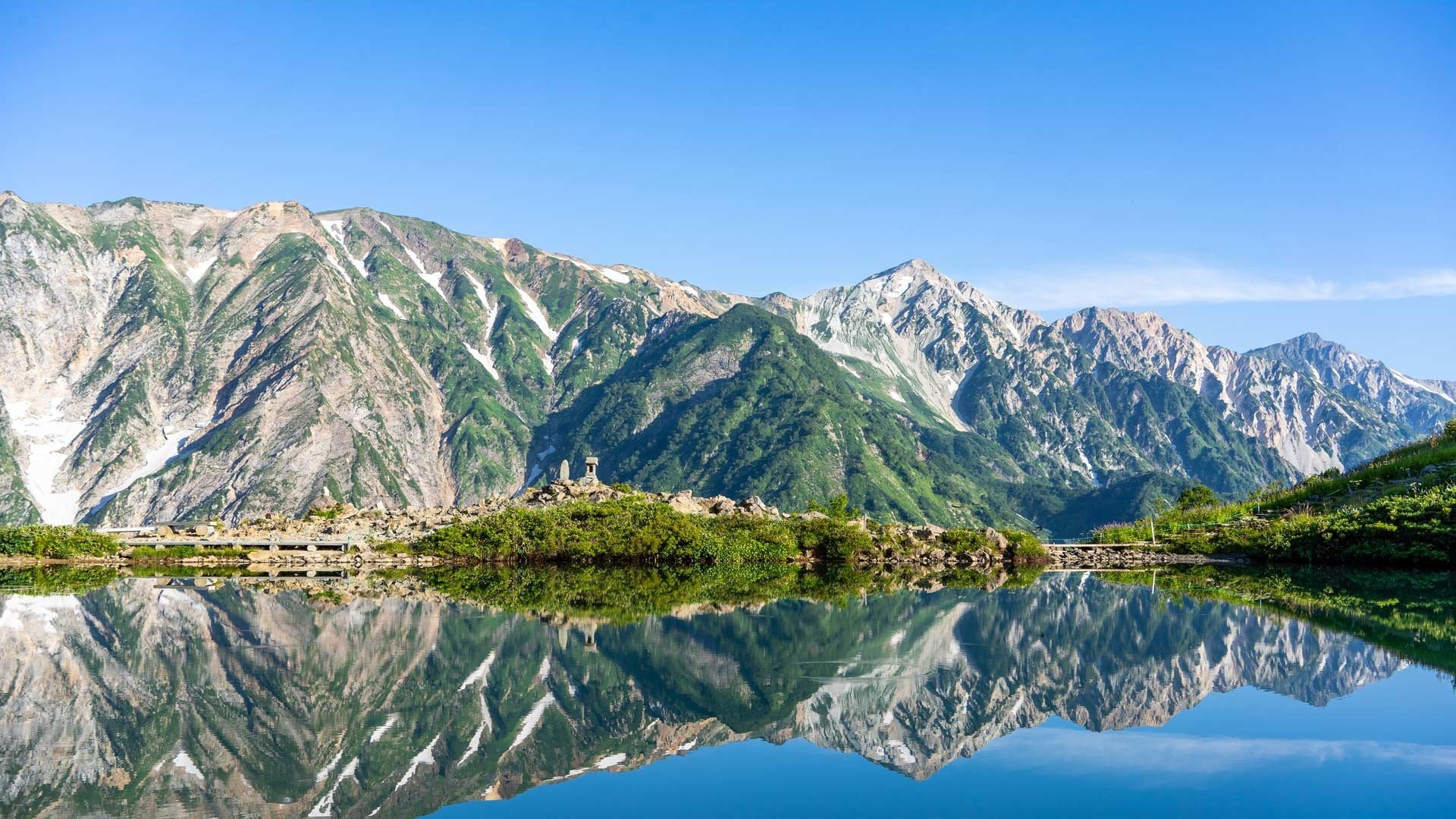HD PC desktop wallpaper/background: Hakuba, Japan — alpine mountains and green slopes reflected in a crystal lake under a clear blue sky.