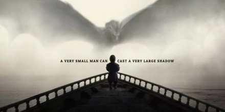 2K Quad HD PC wallpaper: Game of Thrones TV scene — Tyrion Lannister stands on a ship's prow as a colossal dragon emerges from mist; caption reads A very small man can cast a very large shadow.
