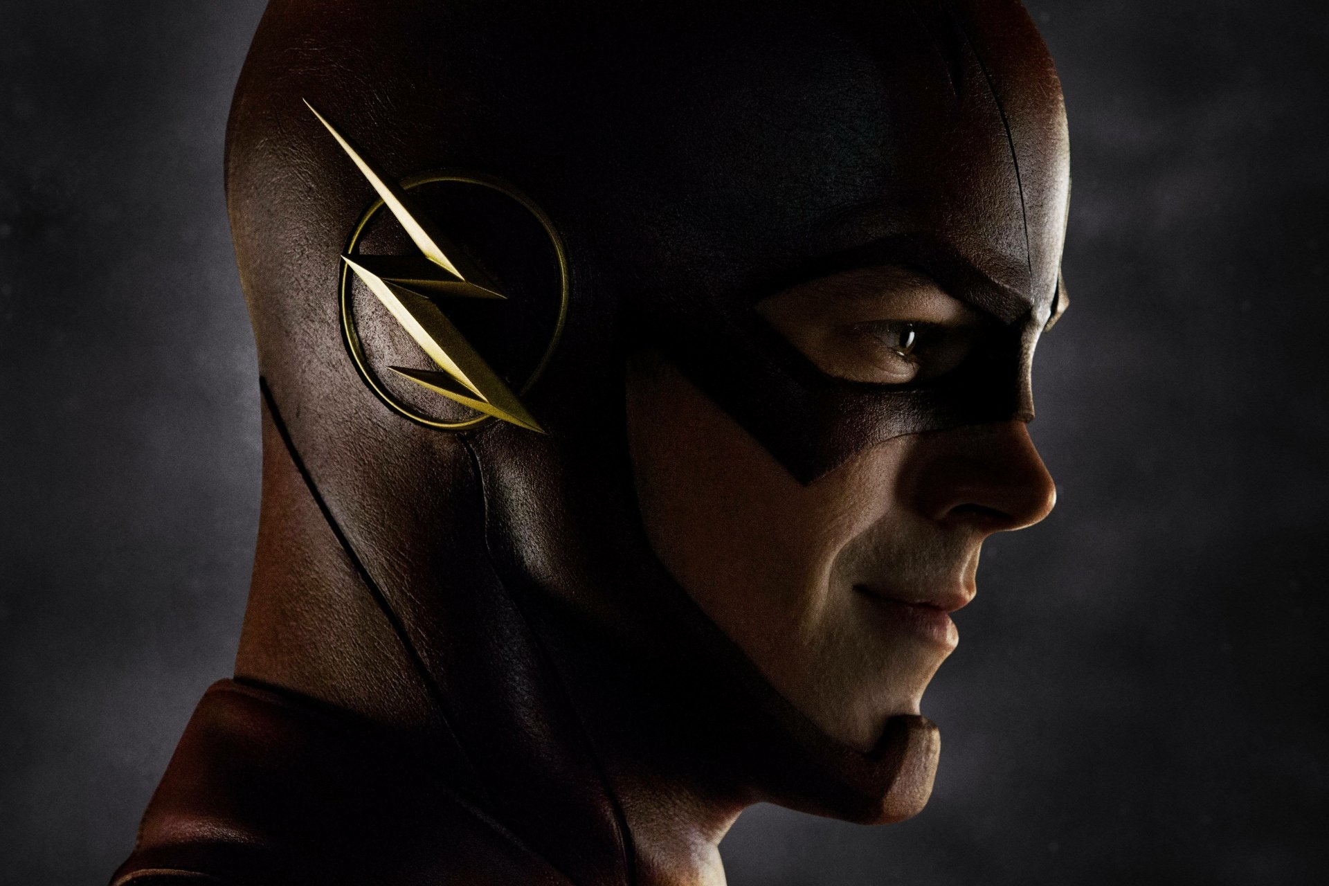 HD desktop wallpaper of Grant Gustin as Barry Allen in his Flash costume, featuring a close-up side profile against a dark background.