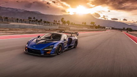 A McLaren Senna supercar speeds along a racetrack at sunset, captured in stunning 4K Ultra HD for a dynamic PC desktop wallpaper.