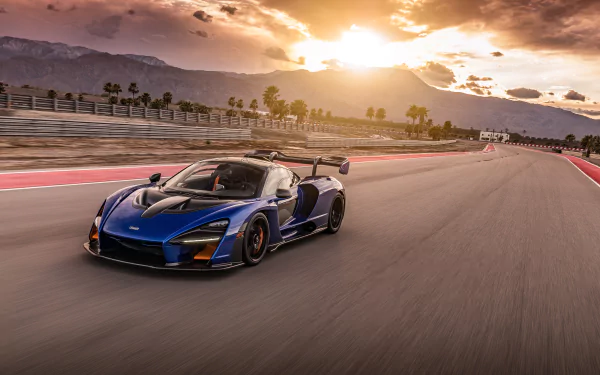 A McLaren Senna supercar speeds along a racetrack at sunset, captured in stunning 4K Ultra HD for a dynamic PC desktop wallpaper.