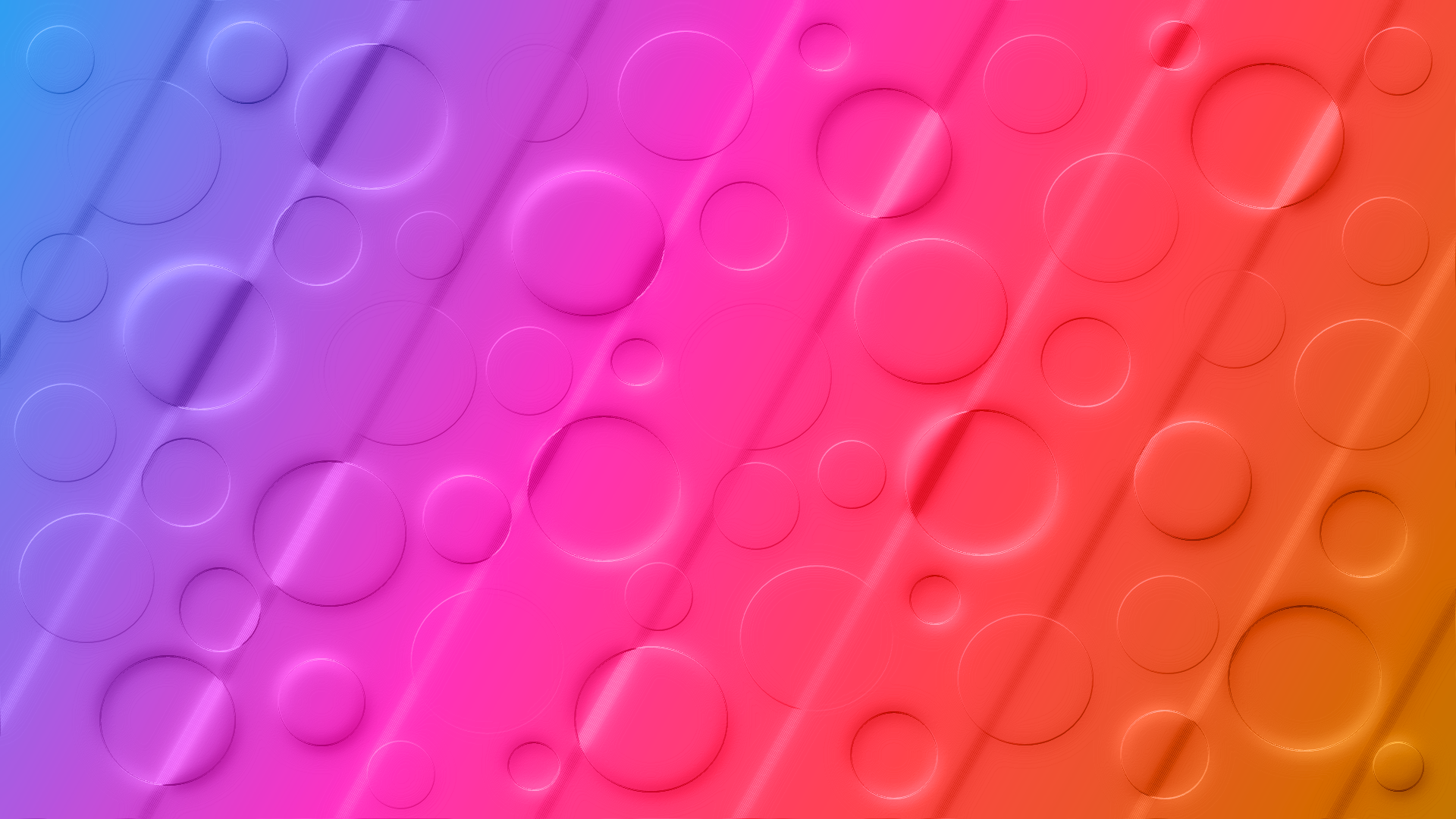 Colorful HD PC desktop wallpaper: abstract gradient from blue through pink to orange with diagonal bands and embossed circular shapes in varying sizes.