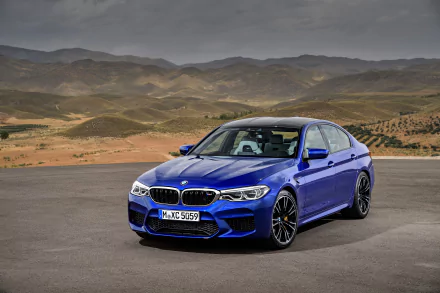 Blue BMW M5 sports sedan parked on open road with rolling hills; high-resolution 4K Ultra HD PC desktop wallpaper showcasing a sleek performance vehicle.