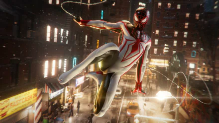 Miles Morales in his Spider-Man suit swings through a glowing cityscape in a dynamic scene from the 4K Ultra HD PC game Marvel's Spider-Man: Miles Morales.