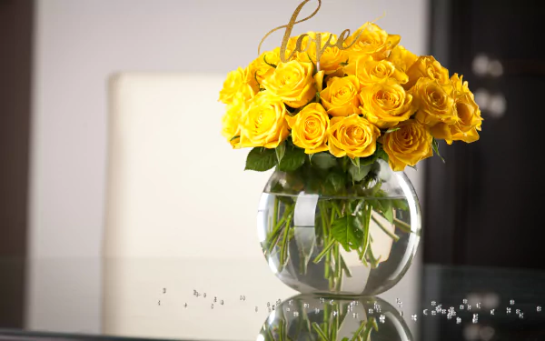 A clear glass vase holding a vibrant bouquet of yellow roses, showcased as a 4K Ultra HD PC desktop wallpaper background.