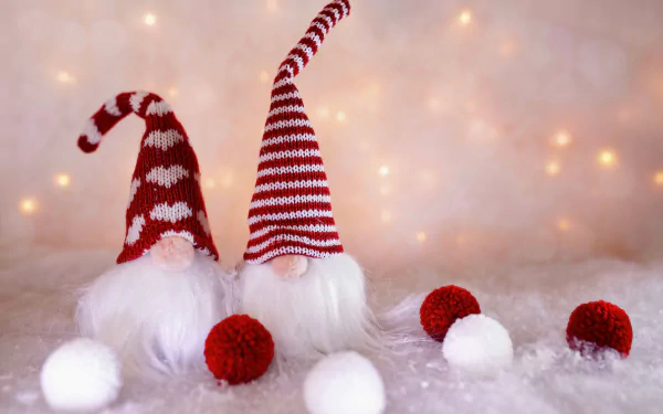 Holiday Christmas 8K Ultra HD PC desktop wallpaper: two red-and-white gnomes with striped hats and fluffy beards on snowy white fur, red and white pom-poms and warm bokeh lights.
