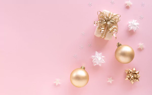 HD PC desktop wallpaper: pink Christmas holiday background with gold baubles, wrapped gift box, stars and small snowflake ornaments.