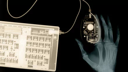 An X-ray vision themed HD desktop wallpaper showcasing a hand holding a computer mouse with internal circuitry visible.