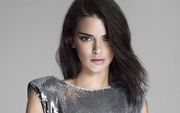 Studio portrait of a female celebrity model with long black hair wearing a silver sequined top, polished 4K desktop wallpaper background.