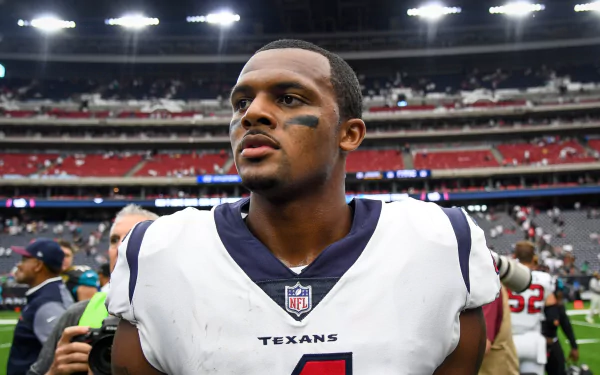 HD desktop wallpaper featuring a football player in a Texans uniform walking on the field.