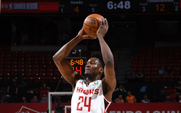HD desktop wallpaper featuring basketball player Bruno Fernando in mid-action on the court, wearing a Hawks #24 jersey.