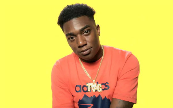 HD desktop wallpaper featuring a person in an orange shirt with a yellow background, tagged as Fredo Bang.