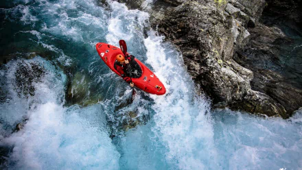 HD wallpaper featuring a kayaker navigating turbulent rapids in a red kayak.