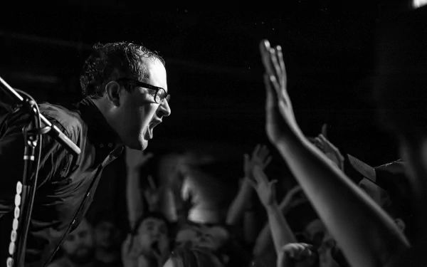 HD desktop wallpaper featuring a monochrome shot of The Hold Steady's lead singer in a live performance connecting with the audience.