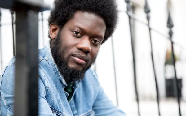 A man leaning on a metal railing serves as a focused and high-definition desktop wallpaper background.