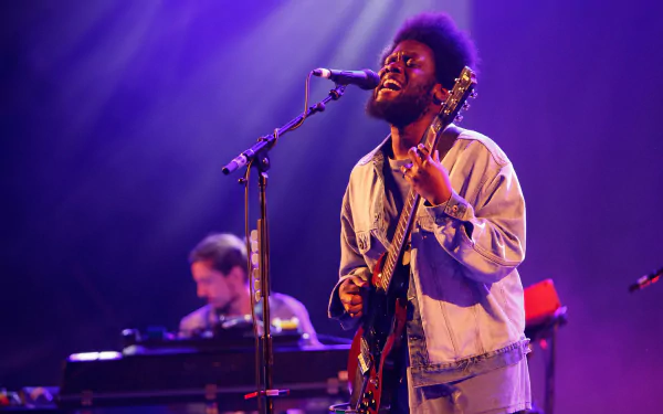 Michael Kiwanuka performing live on stage, HD desktop wallpaper and background.