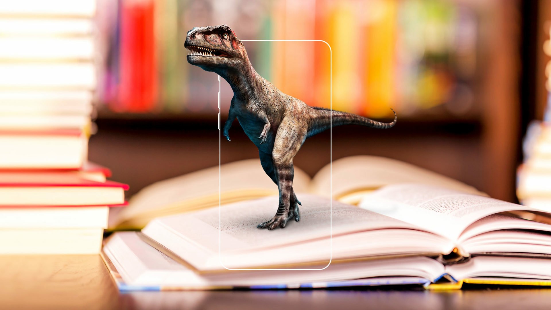 Augmented reality Tyrannosaurus Rex dinosaur emerging from an open book on a desk, with a blurred bookshelf background, in a high-definition desktop wallpaper.