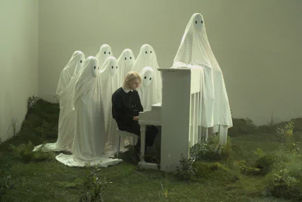 HD desktop wallpaper featuring a figure at a piano surrounded by figures draped in white sheets, evoking a ghostly atmosphere, tagged with Porter Robinson.