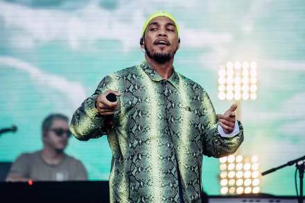 HD desktop wallpaper featuring Anderson .Paak performing on stage with vibrant stage lights in the background.