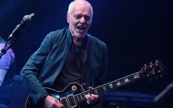 HD desktop wallpaper featuring a live performance by Peter Frampton with his guitar.